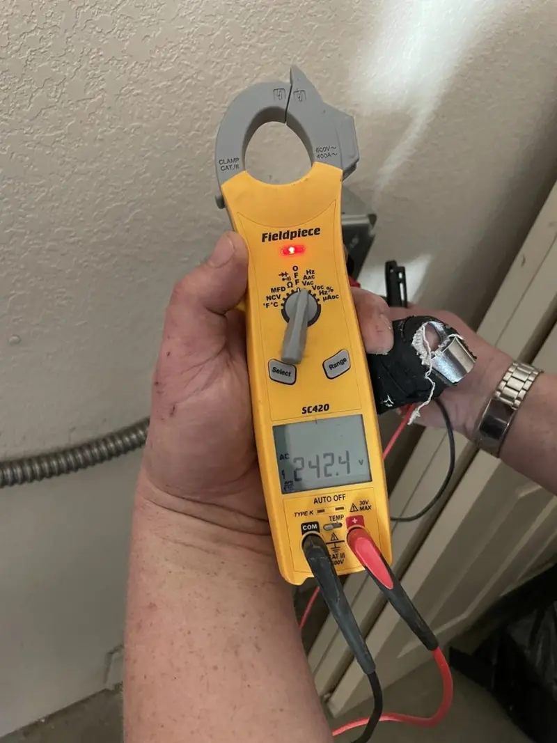 Voltage testing with clamp meter during Outlet Installation in Madison